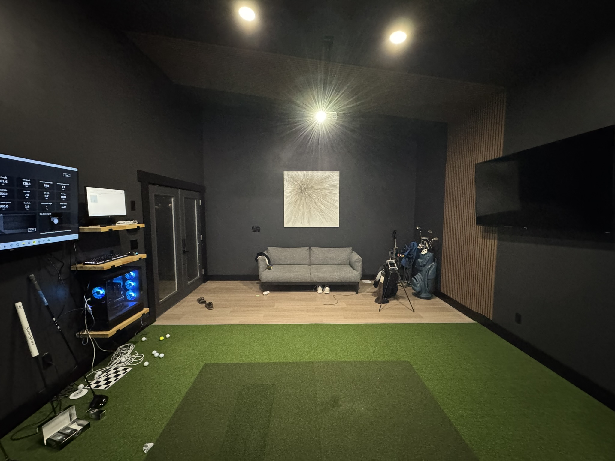 Lounge area with couch and golf bags